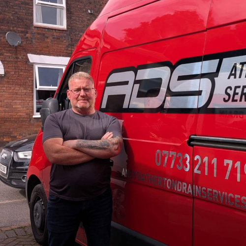 Andy from Atherton Drain Services standing beside the company van